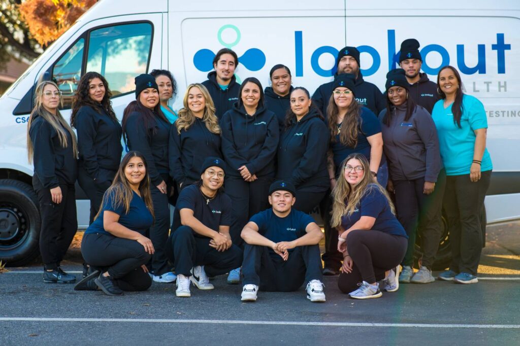Group of Lookout Health Employees in front of white van