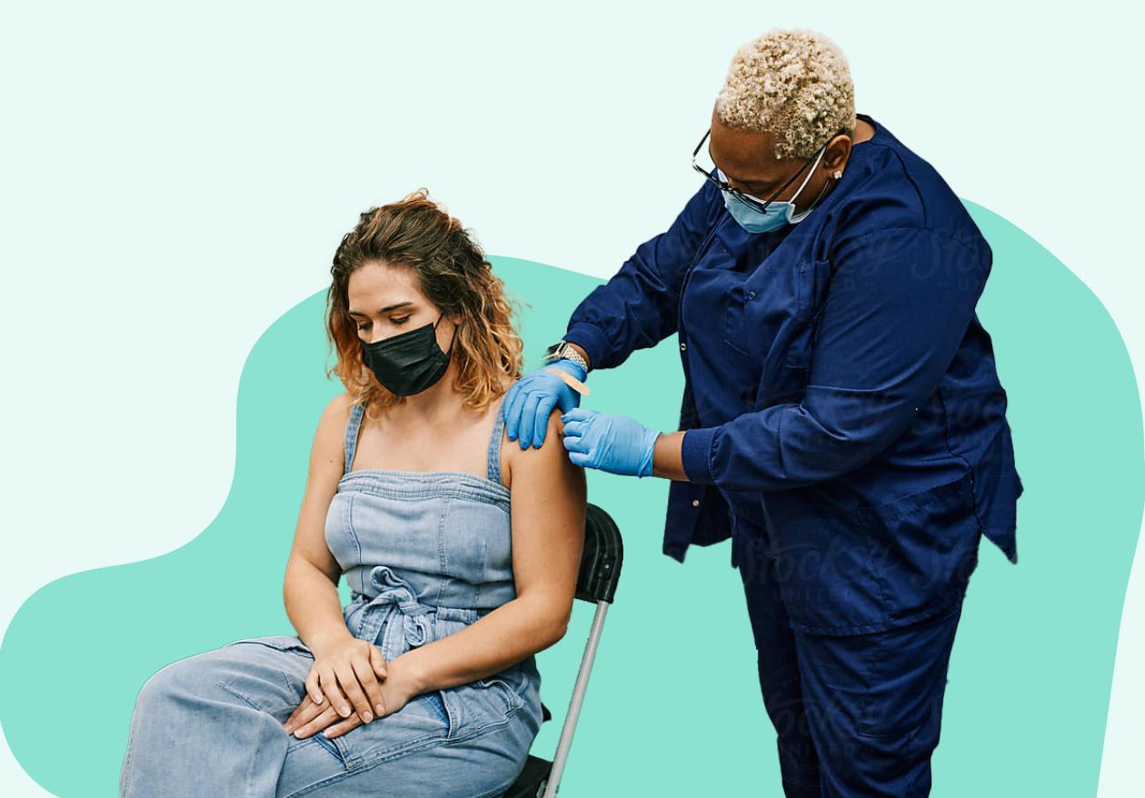 A woman giving another woman a vaccination